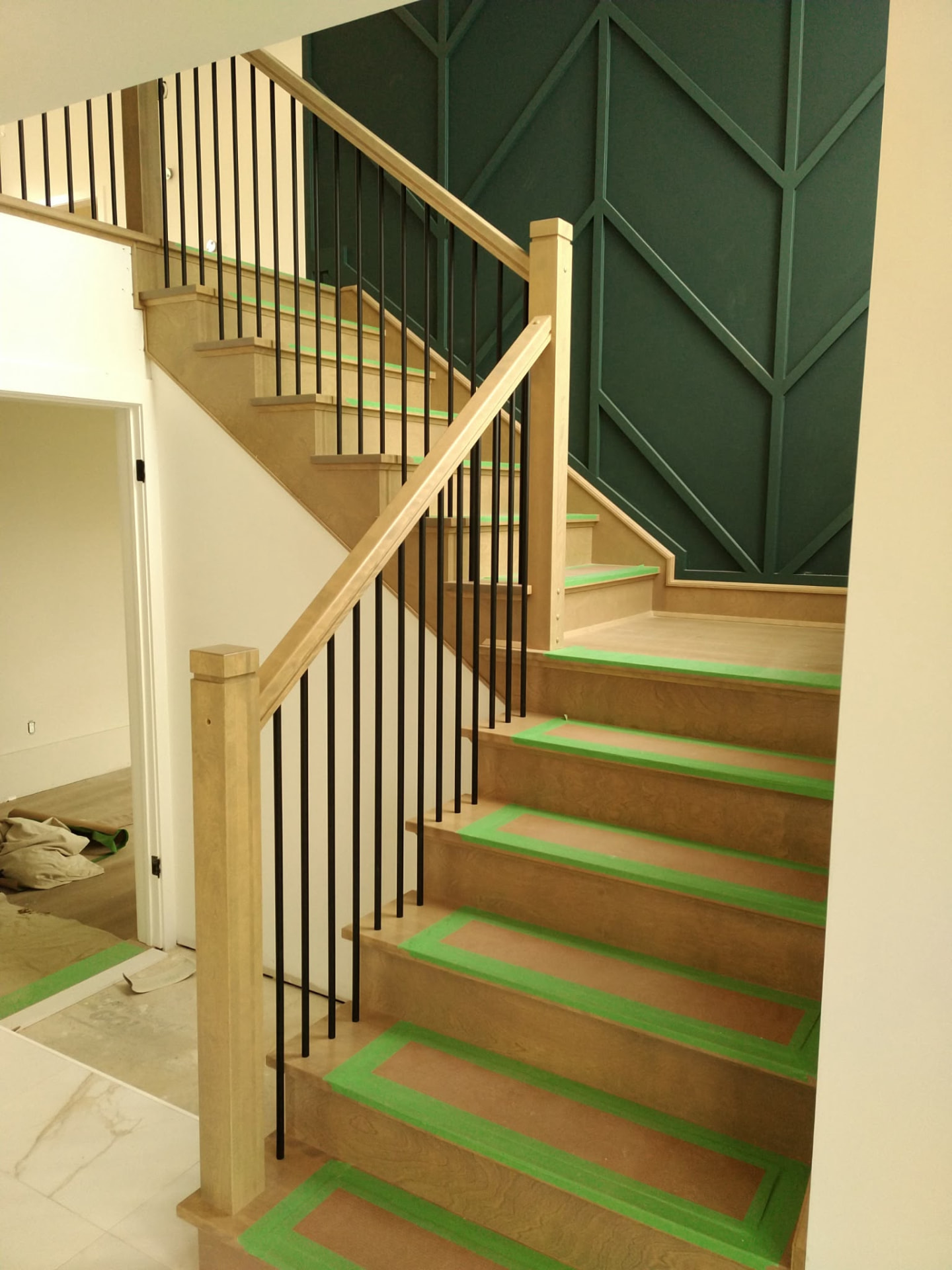Custom hardwood staircase with geometric feature wall