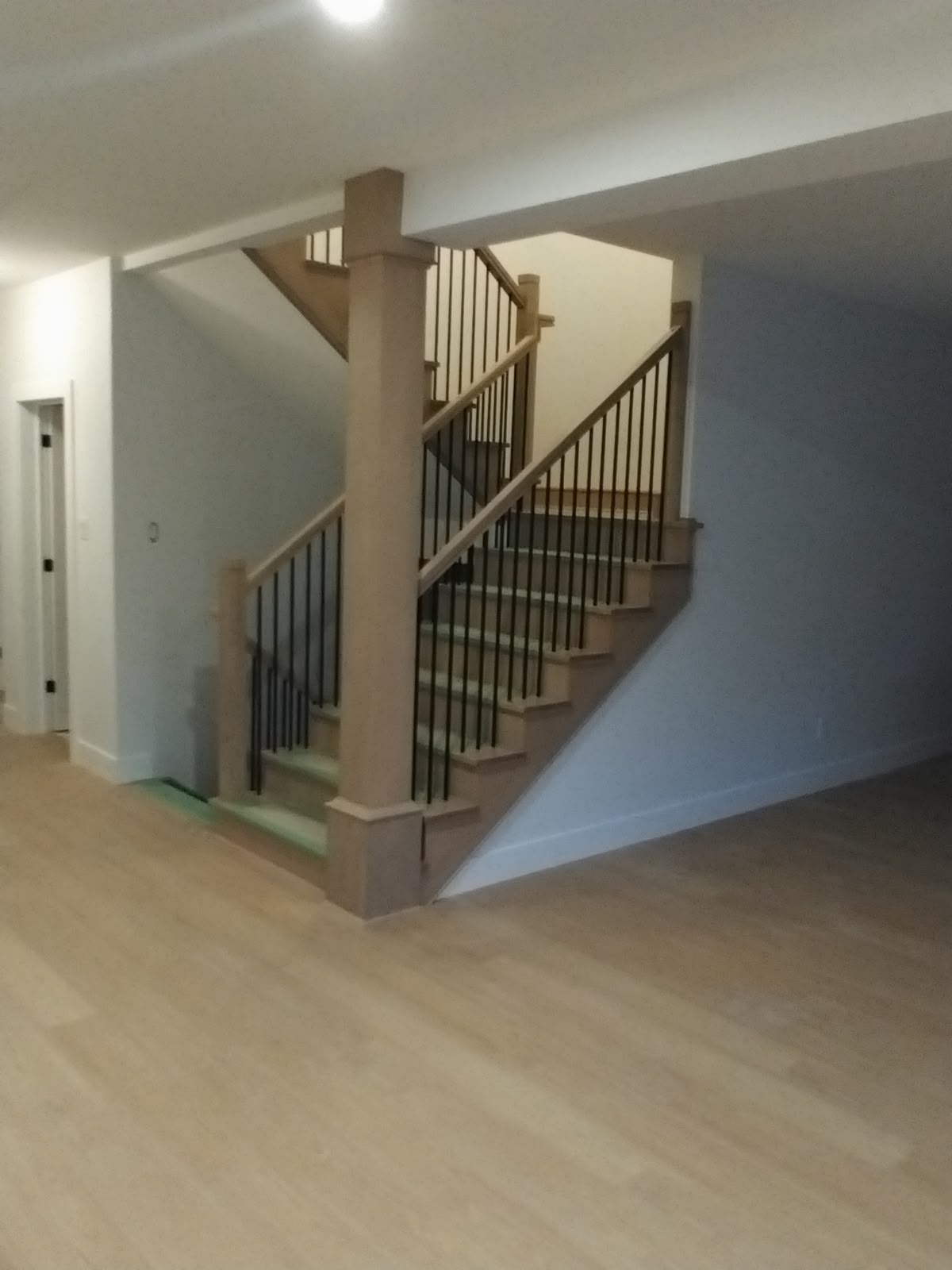 Custom multi-level hardwood staircase with black balusters
