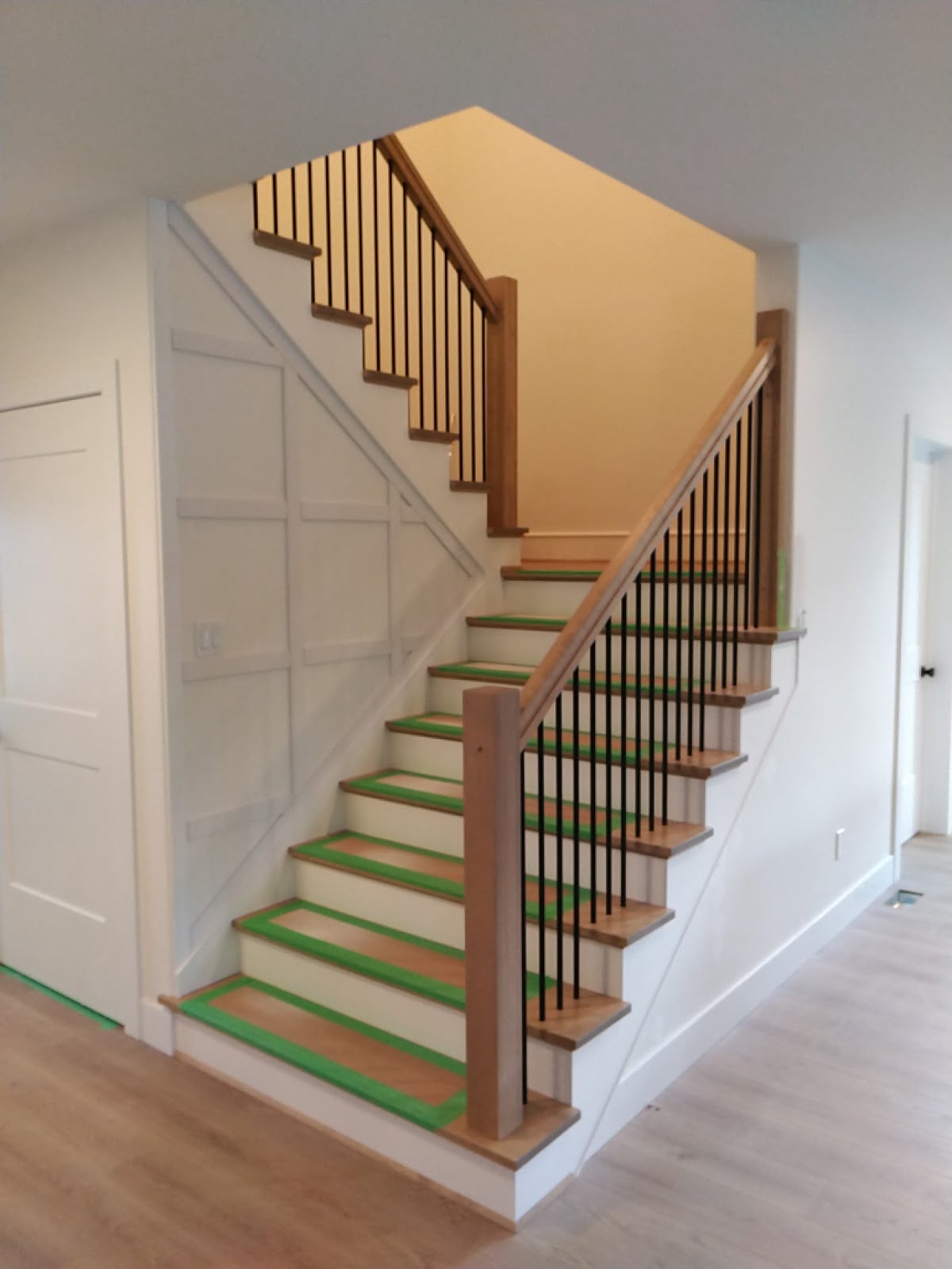 Hardwood staircase with custom geometric wall trim